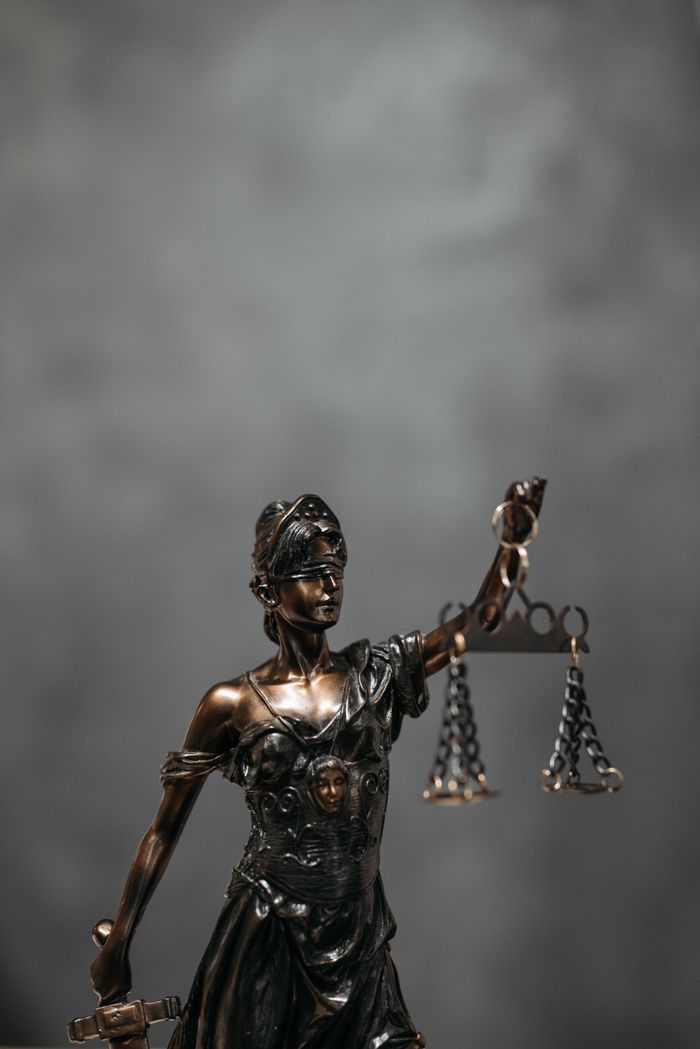 Mastering the First Impression: Your intriguing post title goes here Close-up of a bronze Lady Justice statue holding scales, symbolizing law and fairness.
